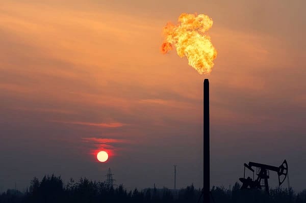 Oil drilling field with flaming Chimney